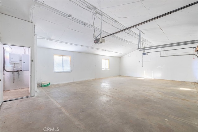 garage featuring a garage door opener and electric panel