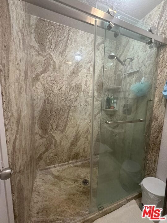 bathroom with a shower with shower door