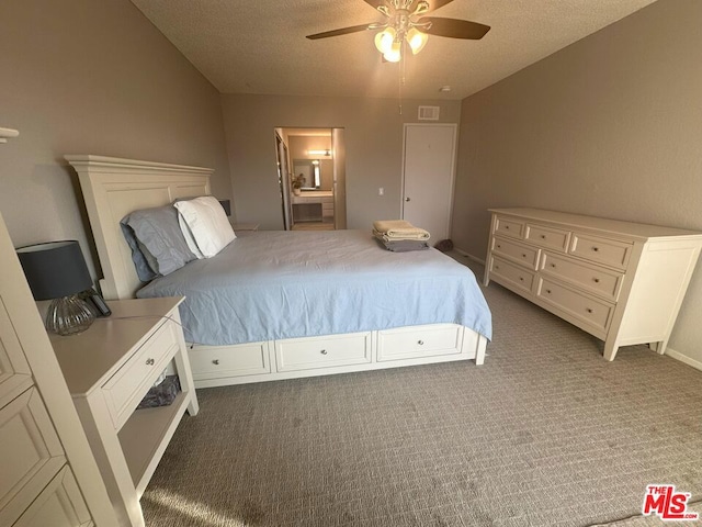 carpeted bedroom featuring a textured ceiling and ceiling fan