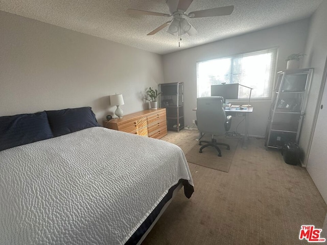 bedroom featuring ceiling fan, carpet floors, and a textured ceiling