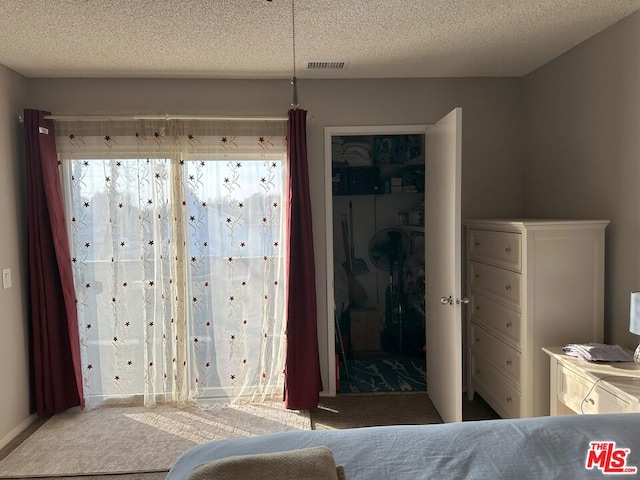 bedroom featuring carpet floors and a textured ceiling