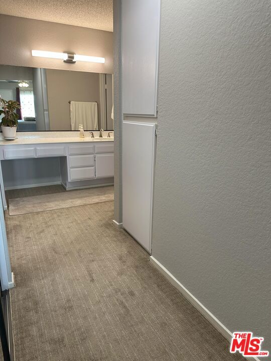 bathroom with vanity and a textured ceiling