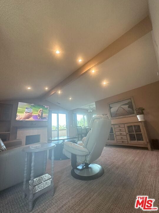 carpeted living room with vaulted ceiling with beams