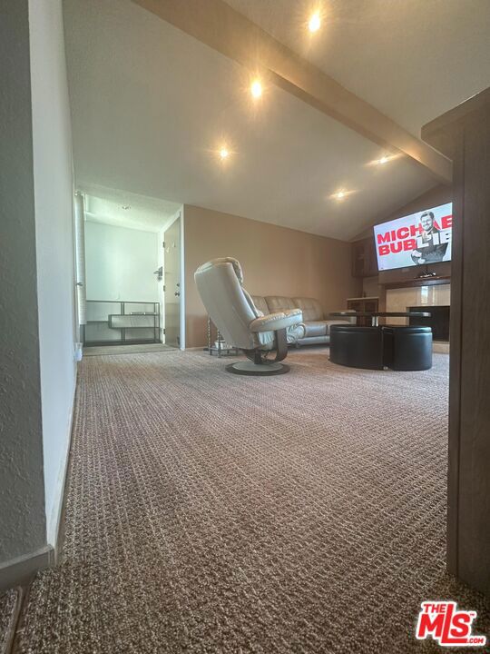 interior space featuring lofted ceiling and carpet floors