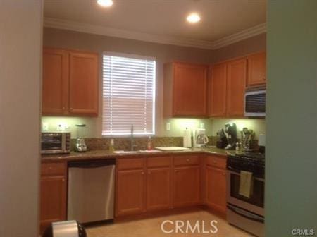 kitchen featuring sink, crown molding, and stainless steel appliances