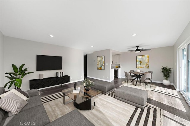 living room with hardwood / wood-style flooring and ceiling fan