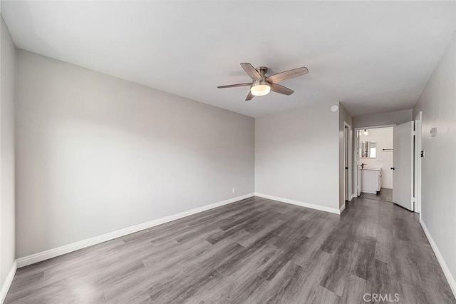 unfurnished room featuring dark hardwood / wood-style floors and ceiling fan