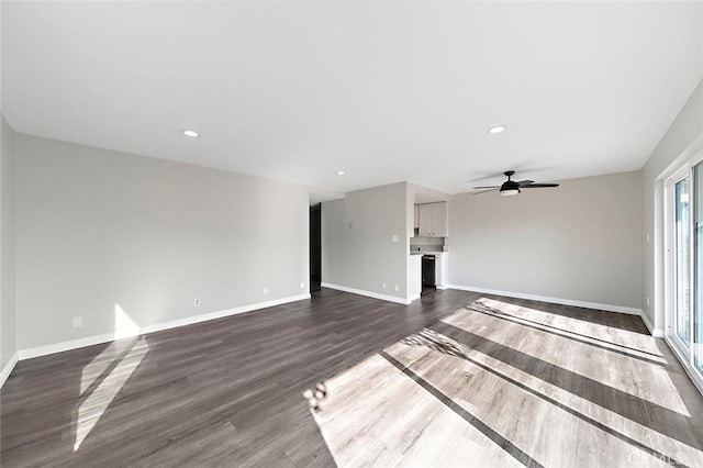 unfurnished living room with dark hardwood / wood-style flooring and ceiling fan