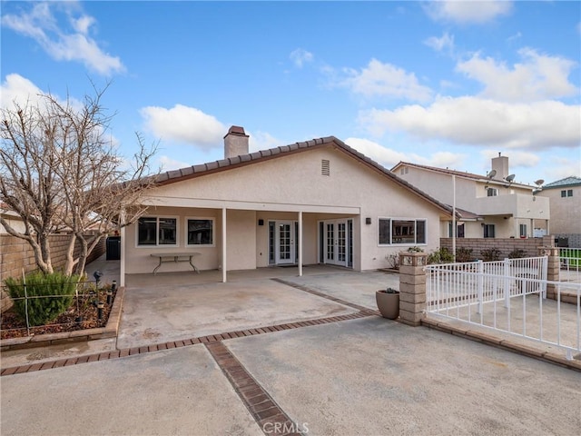 view of front of house with a patio and french doors