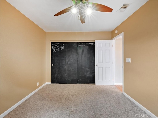 unfurnished bedroom featuring ceiling fan and carpet flooring