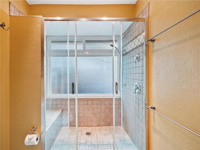 bathroom with a shower with door