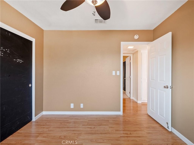 spare room featuring ceiling fan and light wood-type flooring