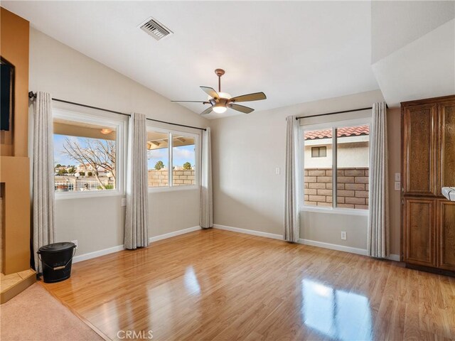 interior space with vaulted ceiling, ceiling fan, and light hardwood / wood-style flooring