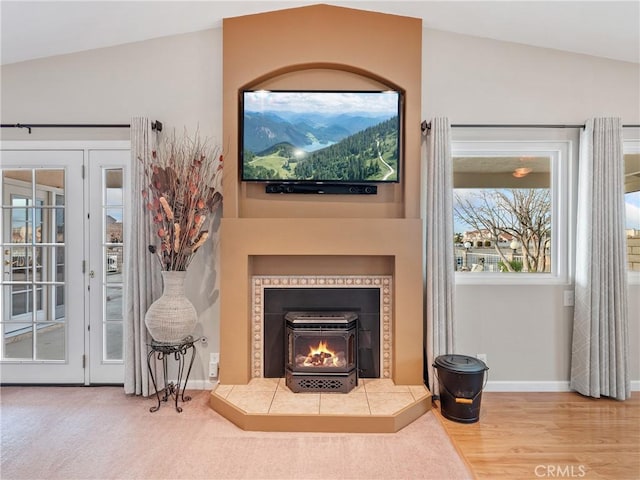 living room featuring lofted ceiling and hardwood / wood-style floors