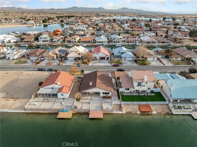 drone / aerial view featuring a water and mountain view