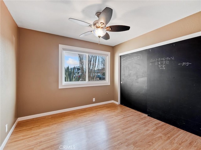 spare room featuring ceiling fan and light wood-type flooring