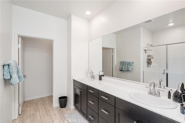 bathroom with vanity, hardwood / wood-style floors, and walk in shower