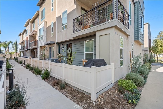 exterior space featuring a residential view and fence