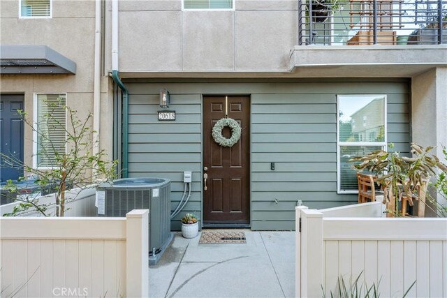 entrance to property featuring a balcony and central AC unit