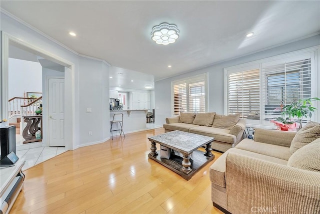 living room featuring ornamental molding and light hardwood / wood-style floors