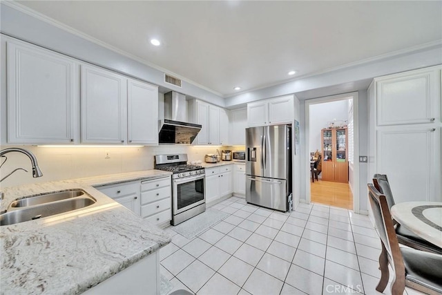 kitchen featuring wall chimney exhaust hood, white cabinetry, stainless steel appliances, and sink