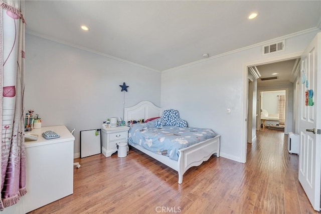 bedroom featuring crown molding and hardwood / wood-style floors