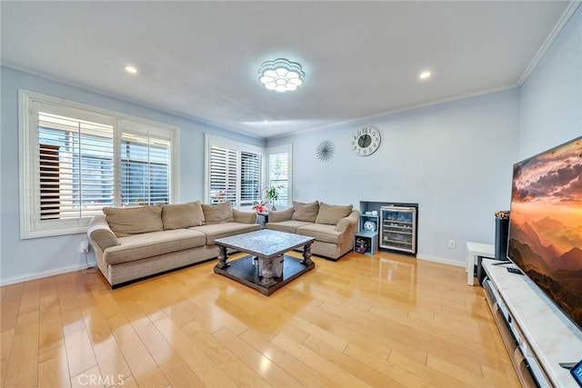 living room with ornamental molding and light wood-type flooring