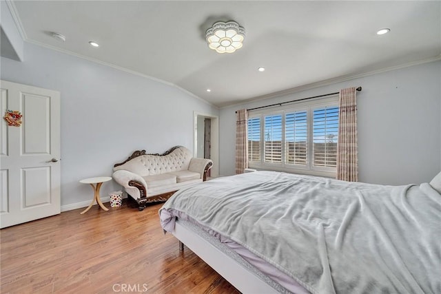 bedroom featuring crown molding, lofted ceiling, and light hardwood / wood-style flooring