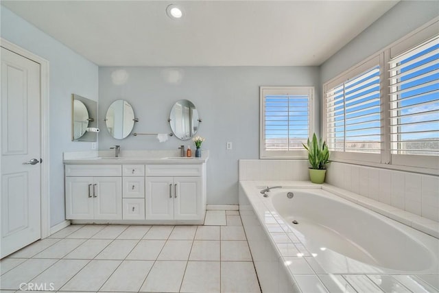 bathroom featuring vanity, tile patterned floors, and tiled bath