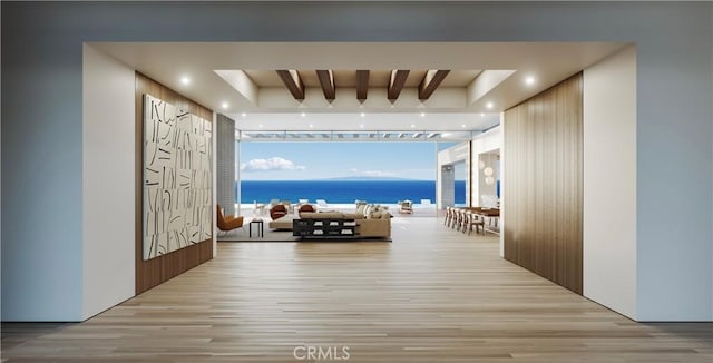 hallway featuring light hardwood / wood-style flooring, a wall of windows, beamed ceiling, and a water view