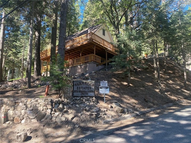 view of side of home with a wooden deck