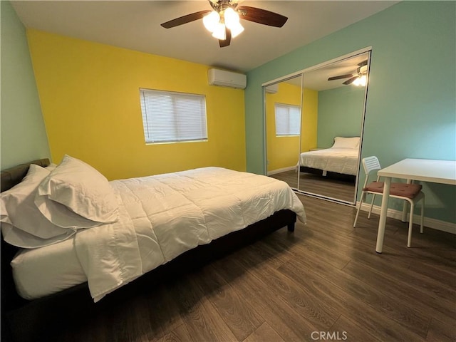 bedroom featuring wood-type flooring, ceiling fan, a wall unit AC, and a closet