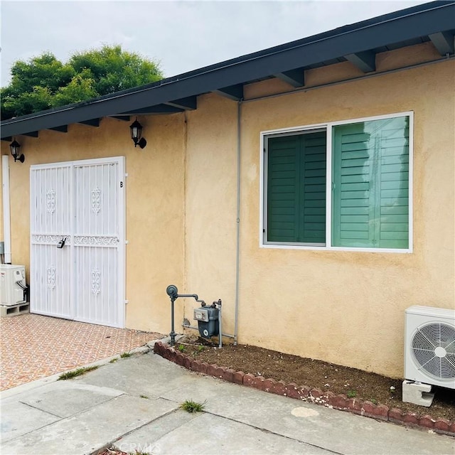 property entrance featuring a patio area and ac unit