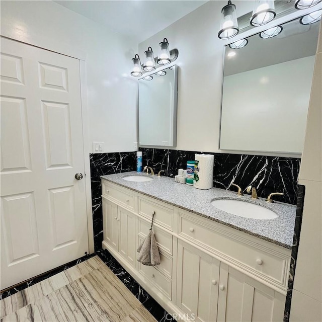 bathroom featuring vanity and tile walls