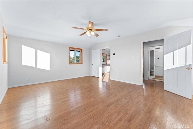 interior space with ceiling fan, lofted ceiling, and light hardwood / wood-style flooring