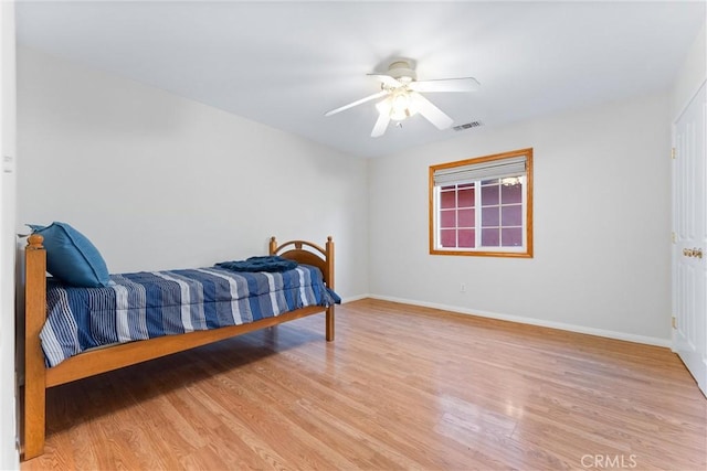 bedroom with light hardwood / wood-style floors and ceiling fan