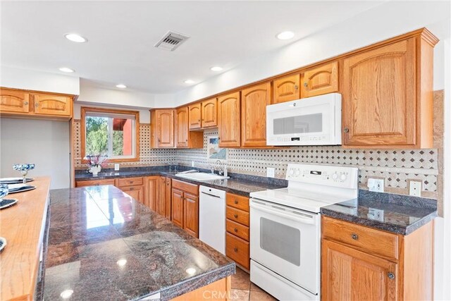 kitchen featuring light tile patterned flooring, sink, white appliances, and decorative backsplash