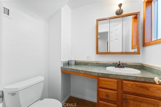 bathroom with tile patterned floors, vanity, and toilet