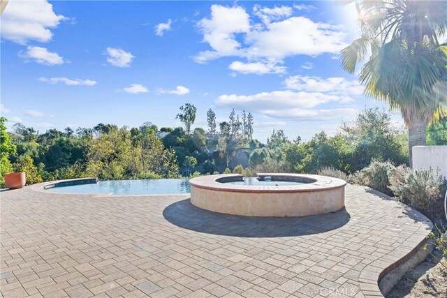 view of swimming pool featuring a patio area