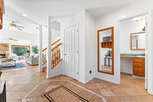 hall featuring sink and light tile patterned floors