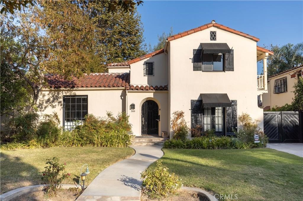 mediterranean / spanish-style home with a front lawn