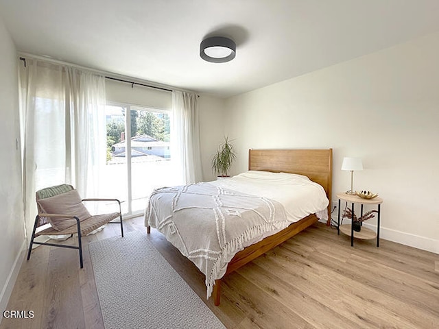 bedroom featuring access to outside and light hardwood / wood-style floors