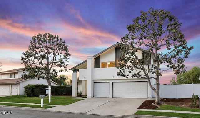 view of front facade featuring a garage and a lawn