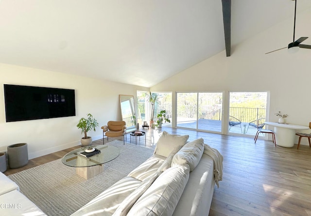 living room with hardwood / wood-style flooring, ceiling fan, beam ceiling, and high vaulted ceiling