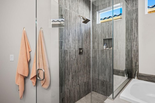 bathroom with separate shower and tub