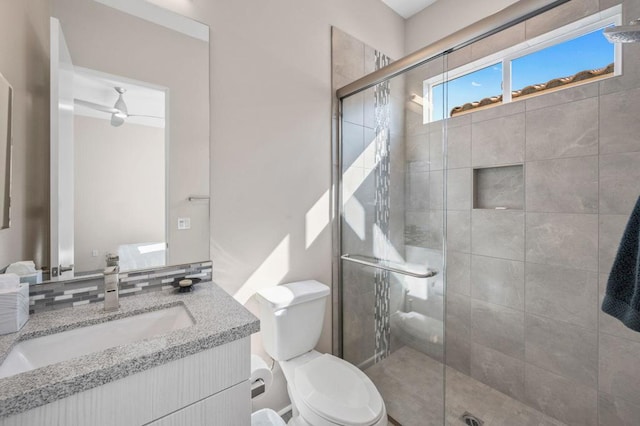 bathroom featuring vanity, toilet, and a shower with door