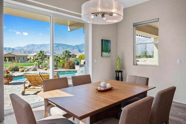 dining space with a mountain view, hardwood / wood-style floors, and a chandelier