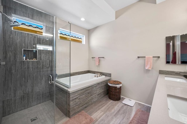 bathroom featuring independent shower and bath, wood-type flooring, and vanity