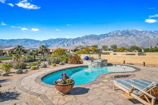 view of pool with a mountain view, a patio, and an in ground hot tub