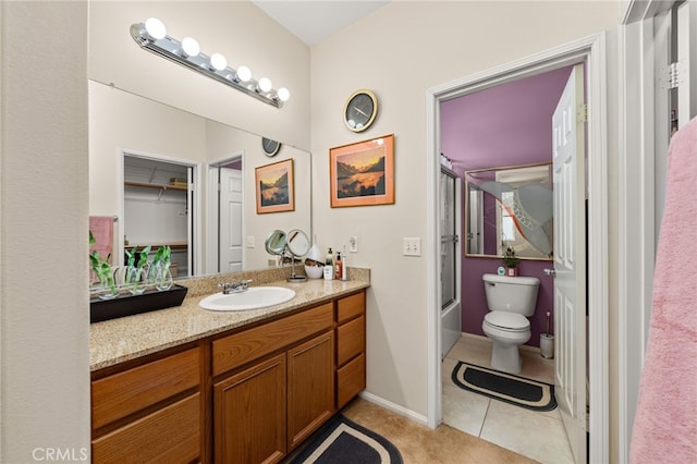 full bathroom featuring enclosed tub / shower combo, vanity, toilet, and tile patterned flooring